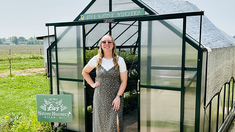 Olivia Onago standing in front of her Liv's Native Nursery.