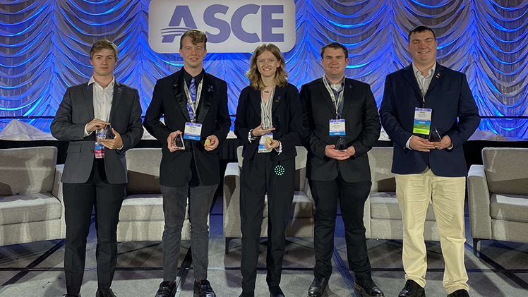 Team of UToledo civil engineering students pose with their third-place trophies, from left: junior Kalvin Tenney, senior Holden Cobb, junior and team captain Carrie Martin, senior Griffin Miller and senior Jason Waisner.