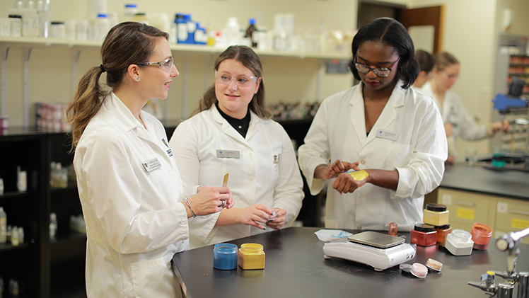 Gabriella Baki, Ph.D., Pharm.D., and two researchers in a UToledo lab.