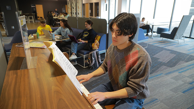 Zeke Strong plays a classical piano piece on the second floor of Carlson Library on Friday afternoon. The mechanical engineering sophomore has been playing for 15 years and often visits the library to practice.