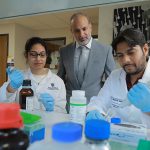 Dr. Zahoor Shah, a neurobiologist and stroke researcher in The University of Toledo College of Pharmacy and Pharmaceutical Sciences, in a lab with two research students.