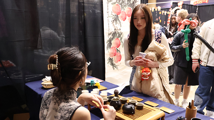 Kaitlyn Myers, a junior studying marketing, listens to visiting Chinese scholar Zijuan Xie as she introduces Chinese tea culture including tasting green tea during the Lunar New Year Celebration hosted by the Center for International Studies and Programs Tuesday afternoon in Thompson Student Union Auditorium.