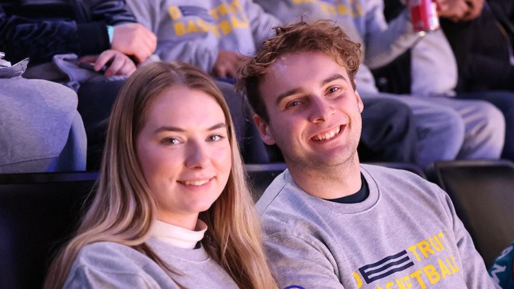 Two UToledo students smile during the UToledo College Night at Detroit Pistons game.