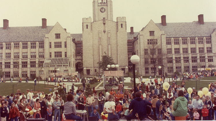 Older color photo of a celebration of University Hall’s 50th anniversary in 1981, during which The University of Toledo hosted events and activities including this afternoon outdoor concert for the campus and Toledo communities on Centennial Mall, construction of which was completed about a year before.
