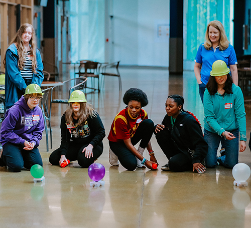 Four girls participate in an experiment during Introduce a Girl to Engineering Day at UToledo.