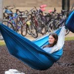 Lucy Jones, an exercise science sophomore, studies in a hammock outside Honors Academic Village during a brief period of unseasonably warm weather before Spring Break.