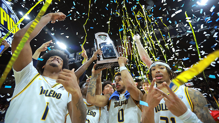 The Toledo men's basketball team celebrate after beating Kent State 86-71 to capture the team’s fourth consecutive outright Mid-American Conference title.