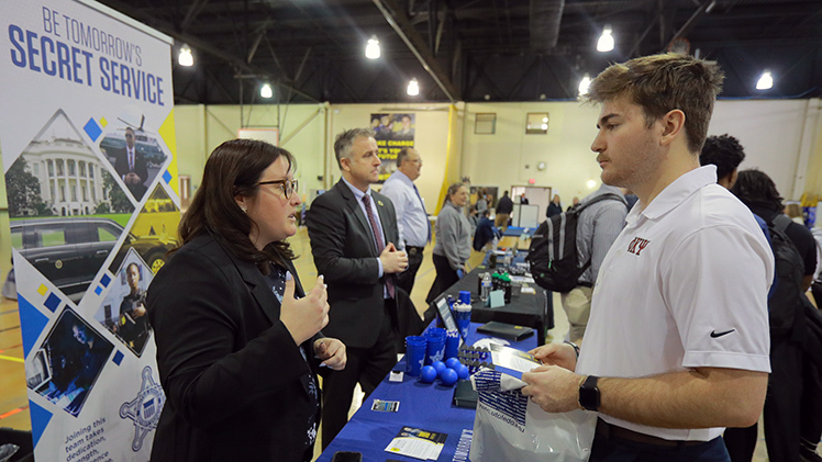 Kieran McSweeney, a sophomore criminal justice student, interviews with the U.S. Secret Service during the Criminal Justice Career and Internship Fair in the Health Education Building.
