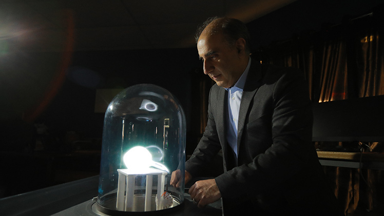 Dr. Abbas Semnani, an associate professor in the Department of Electrical Engineering and Computer Science, examines a plasma-surrounded antenna. His latest research, supported by an NSF CAREER Award, explores microplasmas for more powerful and broadly tunable microwave electronics.