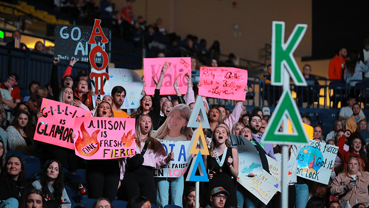 Students attending Songfest cheer on a performance.