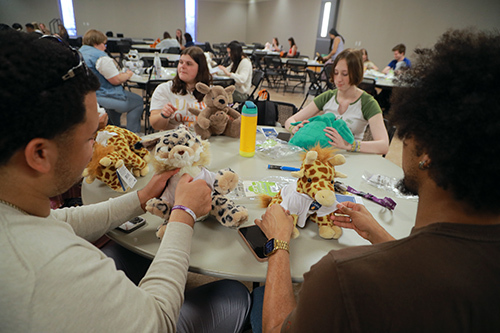 Stuff-a-Plush on Monday at the Thompson Student Union Ingman Room was a popular RocketFest event in which students filled unstuffed plushies to create their own stuffed animals. At bottom left, Russell Chapman III, a marketing and sales student, and at bottom right, Sam Simpson, a mathematics student, and center left, Elanie McWade, an early childhood education student, and center right, Sam Ruff, an English student.