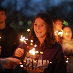 Sydnee McLennan, a marketing student, holds a sparkler during the RocketFest bonfire Friday evening at the flatlands. RocketFest delivered a week of student events and activities on Main Campus