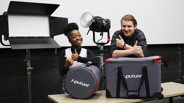 Senior Brooklynn Russell and junior Mike Budich pose with new lighting equipment purchased through one of five proposals funded by the Student Green Fund in the 2023-24 school year.