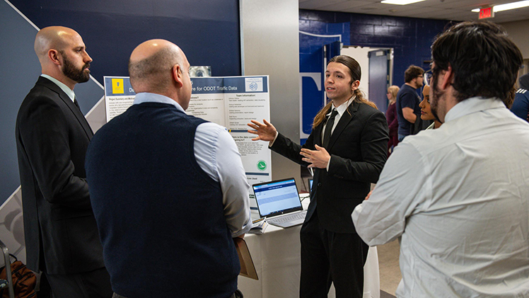 Joseph Gorak, a senior studying computer science and engineering technology, presents his team’s project to faculty and visitors at Friday’s Senior Design Expo and Day of Research on the first floor of Nitschke Hall.