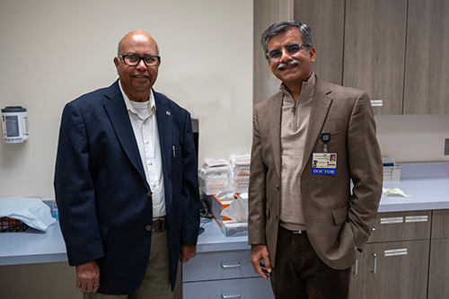Dr. Rafat Ansari, left, poses with Dr. Puneet Sindhwani, the UTMC surgeon who performed Ansari’s kidney transplant.