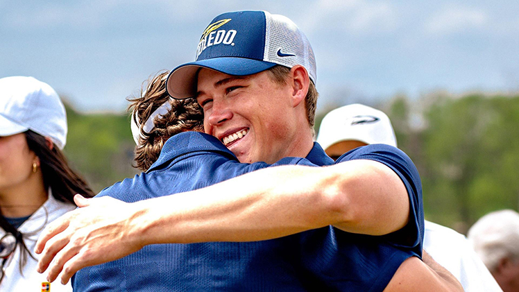 UToledo senior golfer Barend Botha hugs a teammate after winning back-to-back MAC championships.