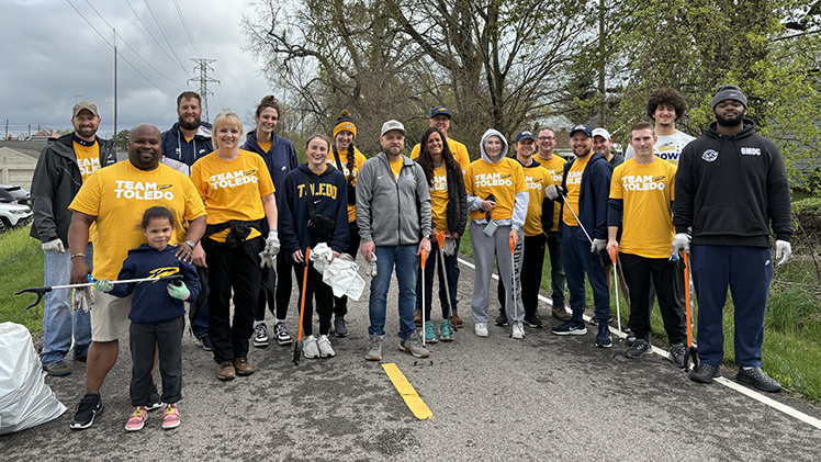 A large group of UToledo student-athletes and Athletic staff pose as they clean up the Toledo community on 419 Day.