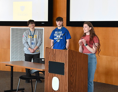 Oskar Czembor and Jacob Davinson, current exchange students at UToledo from the University of Salford, and Serenity Osborne, a UToledo student who participated in the exchange program during the 2022-23 academic year, speak during the UToledo-Salford Exchange 40th Anniversary Celebration and Reunion in Toledo on Saturday, April 13.