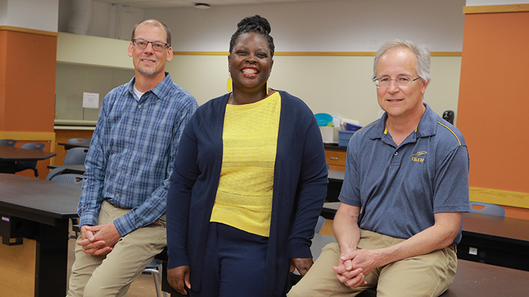 Dr. Natasha Johnson, assistant professor in the Department of Education, center in this group portrait, is leading a $2.3 million initiative to support sixth through 12th grade science teachers in high need districts in Ohio and Kentucky, funded by the National Science Foundation's Robert Noyce Scholarship Program. Her collaborators include Dr. Jonathan Bossenbroek, left, professor and chair of the Department of Environmental Sciences, left, and Dr. Kevin Czajkowski, right, professor in the Department of Geography and Planning.