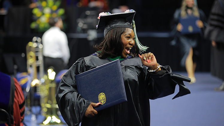 Canaia Booker enjoys the moment after receiving her master of arts degree in counseling education during the doctoral hooding and graduate spring commencement ceremonies on May 3.