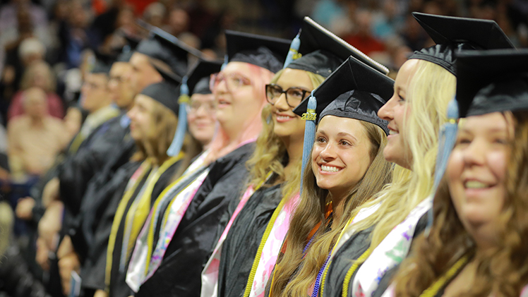 Graduating students in the Judith Herb College of Education smile after receiving their diplomas Saturday morning during The University of Toledo's first of two undergraduate spring commencement ceremonies in Savage Arena.