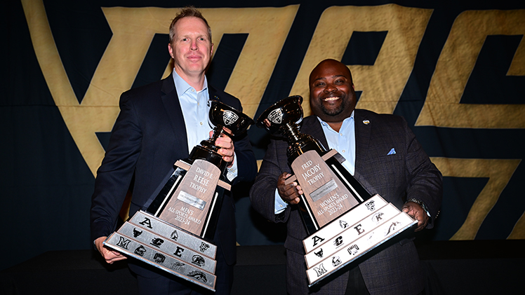 UToledo Interim President Matt Schroeder and Vice President and Director of Athletics Bryan B. Blair each hold a trophy at the MAC Honors Dinner in Cleveland on Thursday evening.