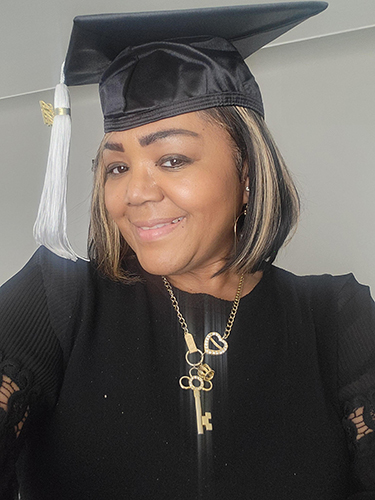 Robin Green, who is graduating May 4, poses for a selfie wearing her mortar board.