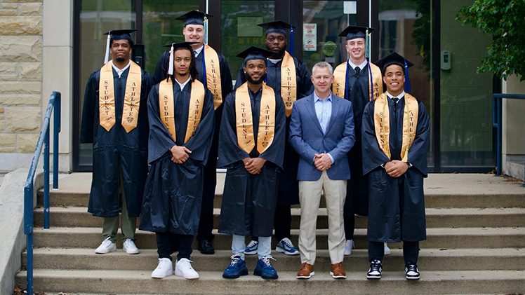 Toledo Football Head Coach Jason Candle gathered with graduates before the 2024 Spring Commencement on May 4.