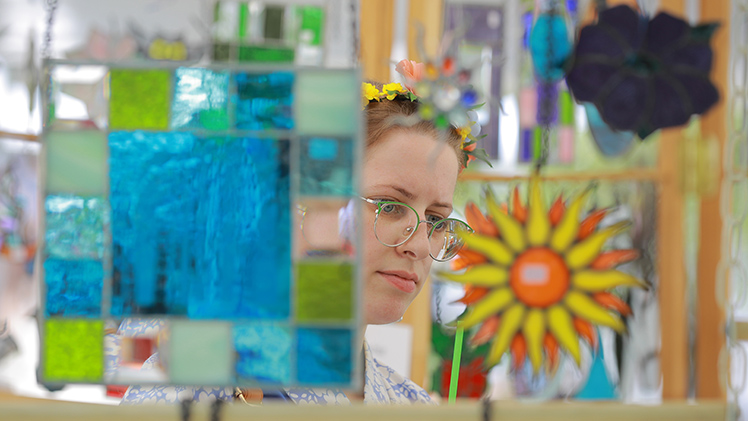 Emily Pedigo, from Toledo, shops in Michigan artist Marie Schweitzer’s colorful glass booth. 