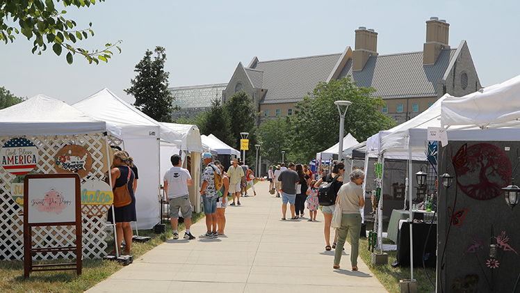 Dozens of attendees at various booths at the 2024 Art on the Mall event.