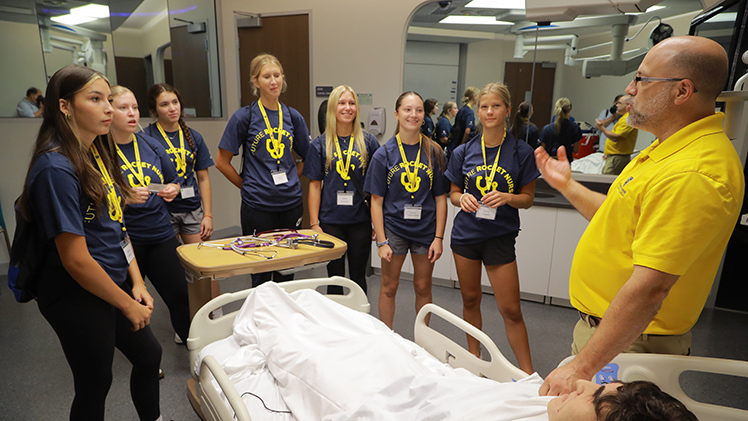 Jim Oberlander, an instructor and director of the pre-licensure bachelor of science in nursing program, explains CPR to high school students participating in The University of Toledo College of Nursing Rocket Nursing Camp on Wednesday in the Interprofessional Immersive Simulation Center.