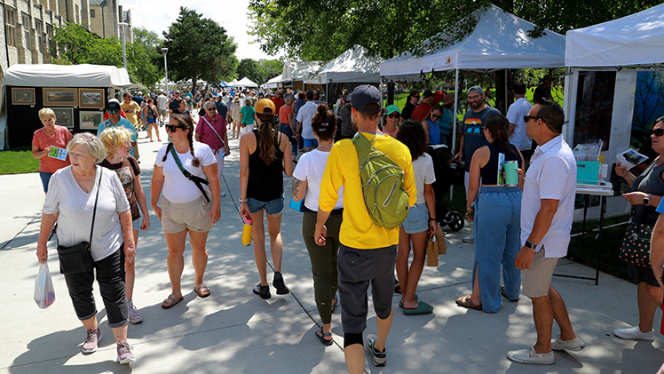 Photo of a crowd entering a busy Art on the Mall in 2023 on Centennial Mall on Main Campus.