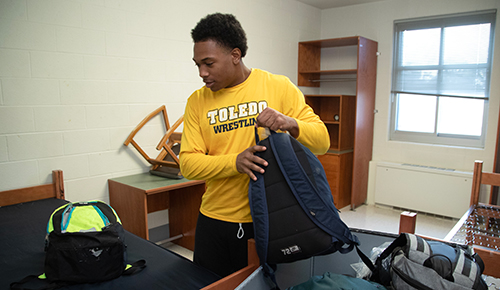 Jeremy Edwards, a sophomore majoring in early childhood education, unpacks in his room in President's Hall Thursday as students moved into residence halls. 