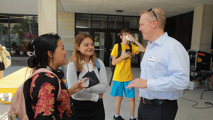 Shristi Gurung, left, and Megha Poudel, both freshman nursing students, chat with Interim President Matt Schroeder during UToledo’s annual Sundae on a Monday event earlier this week outside of Thompson Student Union.