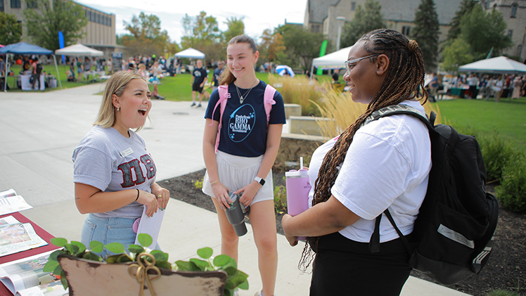 Lauren Perry, from left, a senior studying early childhood education, Analia Biundo, a junior studying cosmetic science, and Quinnekwa Pratt, a senior studying psychology, talk at the Pi Beta Phi sorority table during Wednesday's Campus Involvement Fair.