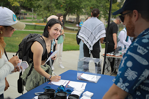 A UToledo students talks with a representative from the MARCOM department at the Campus Involvement Fair.