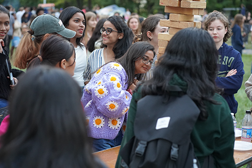 Students play Jenga at the 2024 bonfire on the flatlands as part of the Rocket Welcome Weekend.