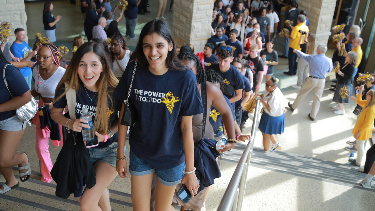 Incoming UToledo freshmen for the 2024-25 academic year are celebrated Friday afternoon as they enter Savage Arena to applause, cheers and cowbells by campus leaders, faculty and staff as part of Rocky’s Welcome, the annual new student convocation ceremony.