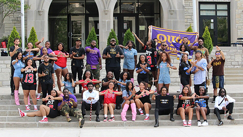 members of the Divine Nine pose and display their fraternity and sorority hand signs before their annual Jam Session event.