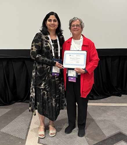 Dr. Margaret “Miggy” Hopkins, a recently retired professor of management at The University of Toledo’s John B. and Lillian E. Neff College of Business and Innovation, holds an award after she was honored earlier this month with the 2024 Academy of Management Diversity, Equity and Inclusion Division Award for Advancing Women in Leadership. 