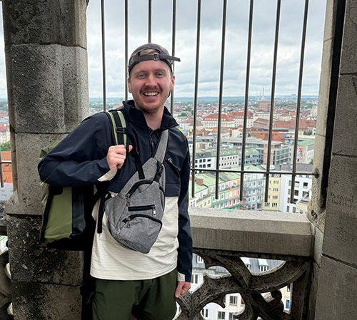 Gregory Zickes, a chemical engineering senior, who spent the summer on a military base in the Netherlands through Rocket Kids, poses for a photo somewhere in Europe.