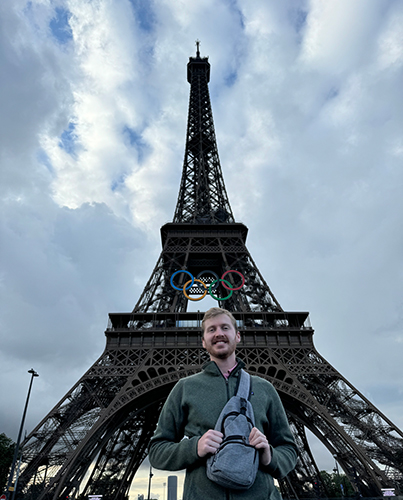 Gregory Zickes, a chemical engineering senior, who spent the summer on a military base in the Netherlands through Rocket Kids, poses for a photo at the bottom of the Eiffel Tower in Paris. 