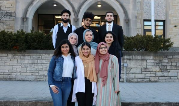 Photo of a a small group of Muslim UToledo students posing for a photo.