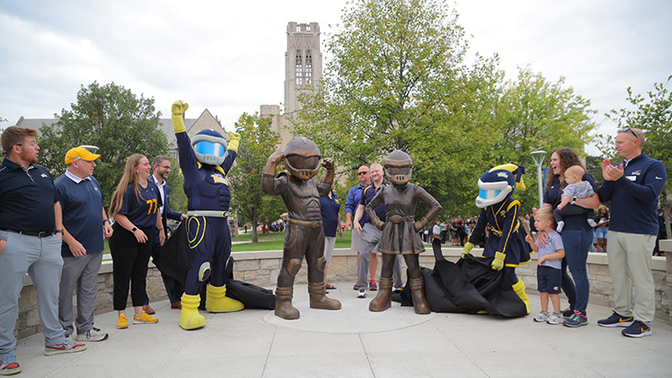 UToledo officials, former mascots, Rocky and Rocksy pose as they unveil the new Rocky and Rocksy statues on the new mascot plaza in Centennial Mall.