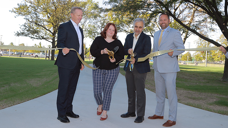 The University of Toledo celebrated the completion of a new greenspace in front of the College of Engineering’s Nitschke Hall on Thursday, including a ribbon-cutting ceremony with, from left, Interim President Matt Schroeder; Alexus Hofacre, an undergraduate student in the College of Engineering; Dr. Mohammad Elahinia, interim dean for College of Engineering; and Jason Toth, senior associate vice president for administration.