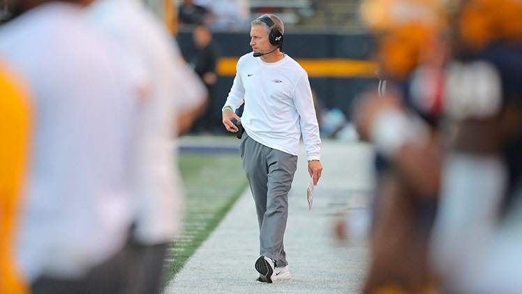 Photo of Toledo head football coach Jason Candle on the sidelines during a game.