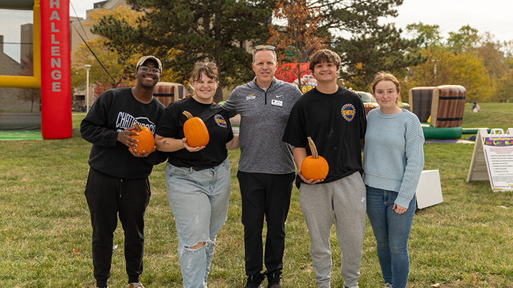 Interim President Matt Schroeder poses with Rockets at the Fall Fest.