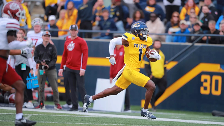 Wide receiver Jerjuan Newton races towards the end zone after a catch.