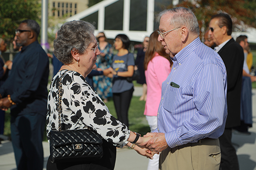 Photo of one older couple holding hands and looking at each other during the 2024 Rocket Romance event on Centennial Mall.