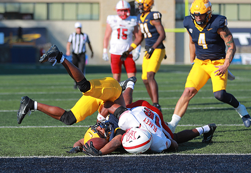 A Toledo Rocket is tackled by a Miami RedHawk during the 2024 Homecoming Game.